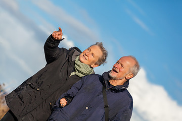 Image showing happy elderly senior couple walking on beach