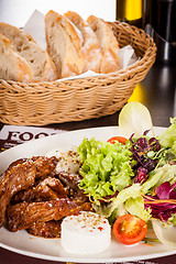 Image showing grilled beef stripes fresh salad and goat cheese