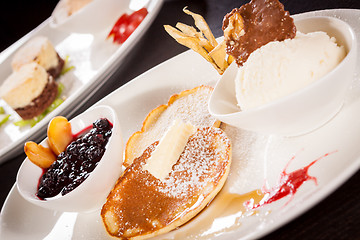 Image showing tasty sweet pancakes with vanilla icecream and topping