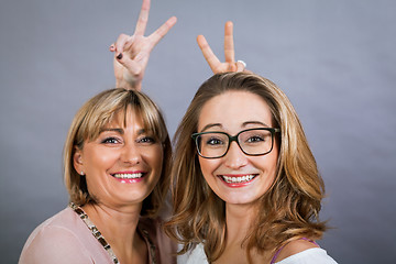 Image showing smiling middle-aged young mother and daughter