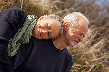 Image showing happy senior couple relaxing together in the sunshine