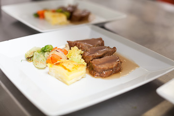 Image showing Chef plating up food in a restaurant