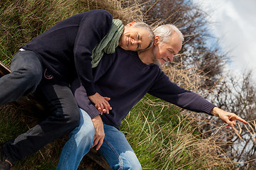 Image showing happy senior couple relaxing together in the sunshine