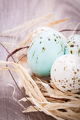 Image showing Three natural blue Easter eggs in a basket