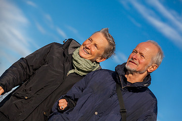 Image showing happy elderly senior couple walking on beach