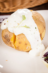 Image showing Baked jacket potato with sour cream sauce