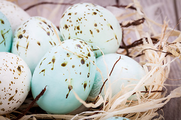 Image showing Three natural blue Easter eggs in a basket