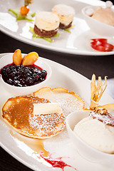 Image showing tasty sweet pancakes with vanilla icecream and topping