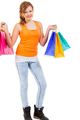 Image showing attractive young woman with colorful shopping bags