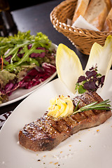 Image showing Grilled beef steak topped with butter and rosemary