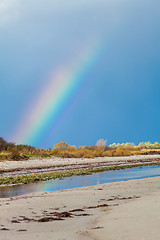 Image showing Rainbow over tidal mud flats at the coast