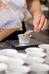 Image showing Chef preparing desserts removing them from moulds
