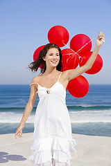 Image showing Beautiful girl holding red ballons