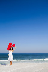 Image showing Beautiful girl holding red ballons