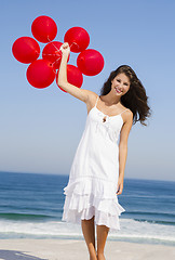 Image showing Beautiful girl holding red ballons