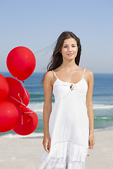 Image showing Beautiful girl holding red ballons