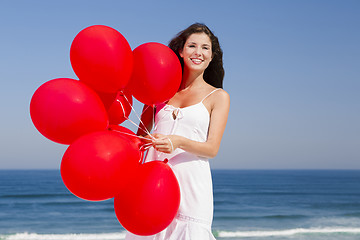 Image showing Beautiful girl holding red ballons