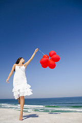 Image showing Jumping with red ballons