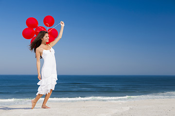 Image showing Beautiful girl holding red ballons