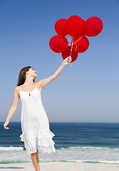 Image showing Beautiful girl holding red ballons