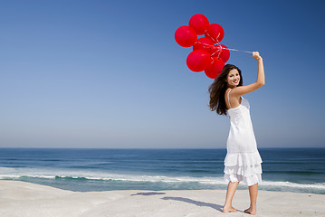 Image showing Beautiful girl holding red ballons