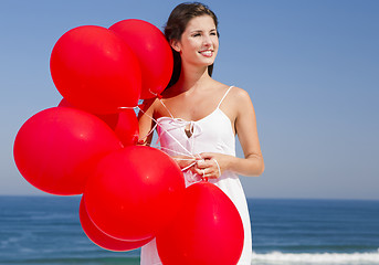 Image showing Beautiful girl holding red ballons