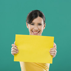 Image showing Holding a yellow paper
