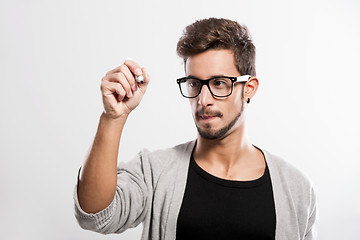 Image showing Young man writing on a glass