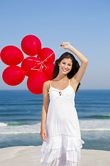 Image showing Beautiful girl holding red ballons