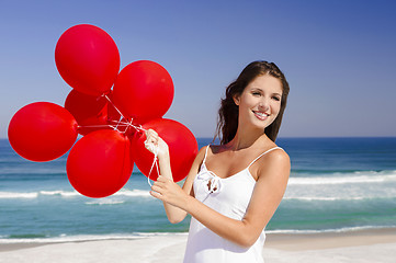 Image showing Beautiful girl holding red ballons