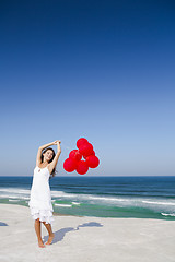 Image showing Beautiful girl holding red ballons