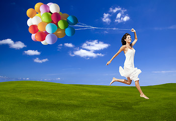 Image showing Jumping with a colored ballons