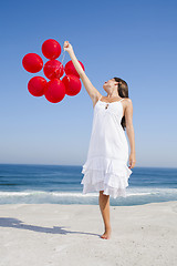 Image showing Beautiful girl holding red ballons