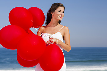 Image showing Beautiful girl holding red ballons