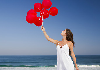 Image showing Beautiful girl holding red ballons