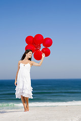 Image showing Beautiful girl holding red ballons