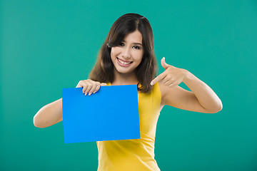 Image showing Holding a blue paper