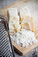 Image showing grated parmesan cheese and metal grater 