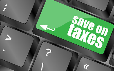 Image showing save on taxes word on laptop keyboard key, business concept