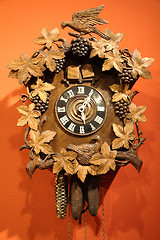 Image showing old wall clock on orange background