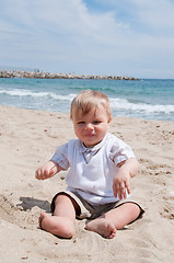 Image showing Happy boy sitting on the beach