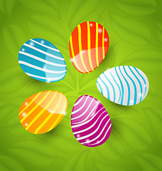 Image showing Easter set colorful ornamental eggs on green leaves background