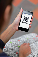 Image showing Woman hand holding mobile phone with QR code coupon