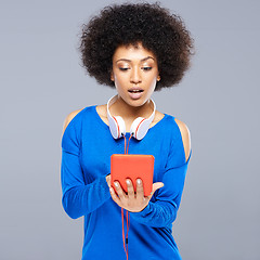 Image showing Beautiful young woman selecting a tune