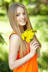 Image showing Spring girl lying on the field of dandelions