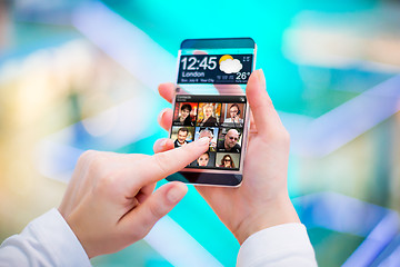 Image showing Smartphone with transparent screen in human hands.