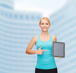 Image showing sporty woman with tablet pc blank screen