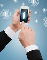 Image showing businessman touching screen of smartphone