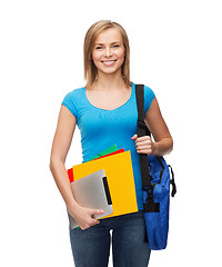 Image showing smiling student with bag, folders and tablet pc