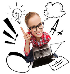 Image showing smiling teenage girl in eyeglasses with laptop